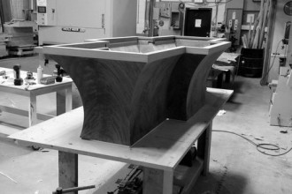 Table pedestal being prepared and fitted on workbench
